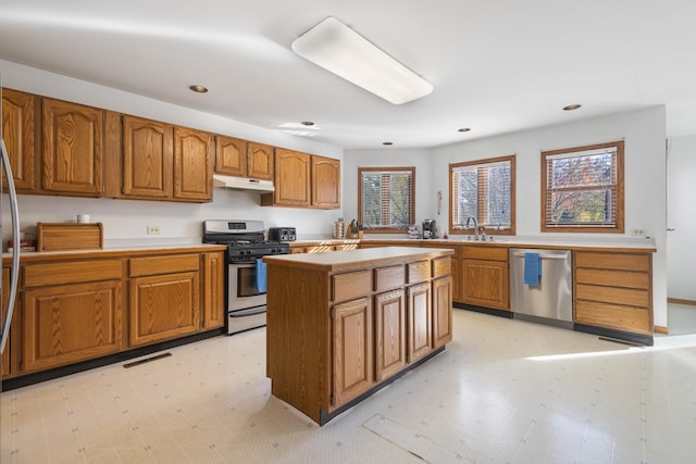 kitchen featuring a center island, stainless steel appliances, sink, and plenty of natural light