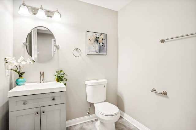 bathroom featuring toilet and vanity