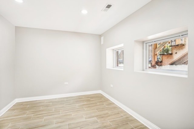 empty room with light hardwood / wood-style flooring