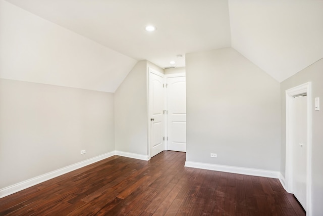 bonus room with vaulted ceiling and dark hardwood / wood-style floors