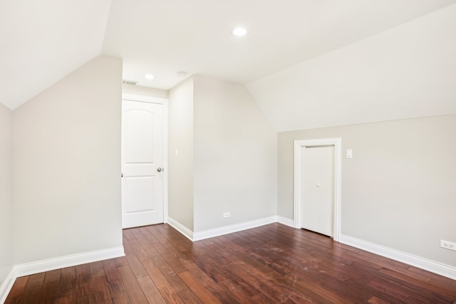 bonus room with lofted ceiling and dark hardwood / wood-style floors