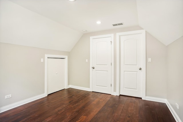 bonus room featuring lofted ceiling and dark hardwood / wood-style flooring