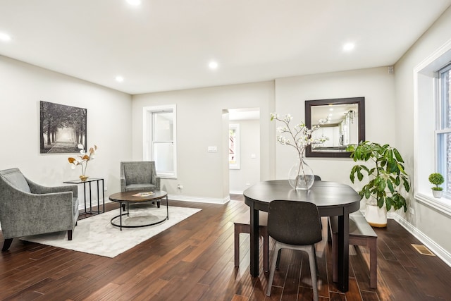 dining area with dark hardwood / wood-style flooring