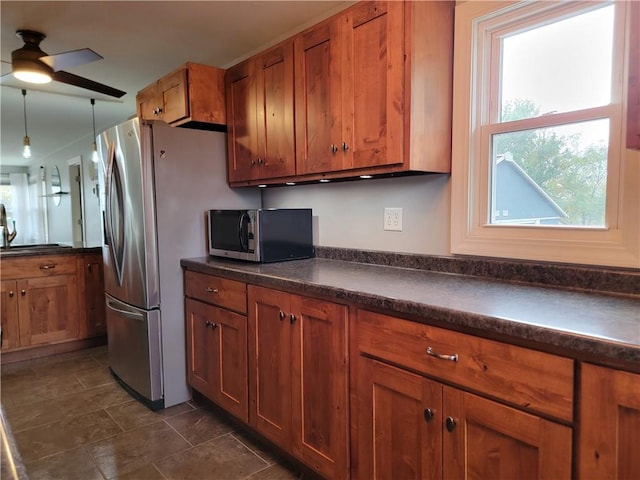 kitchen featuring appliances with stainless steel finishes, decorative light fixtures, and ceiling fan