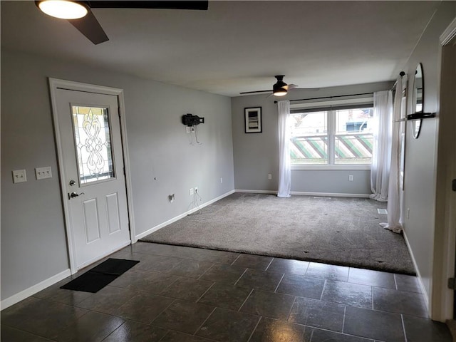 carpeted foyer entrance featuring ceiling fan and a wealth of natural light