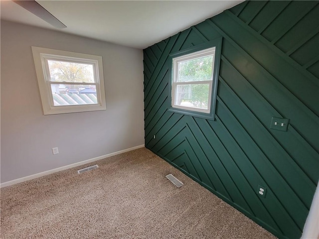 carpeted empty room with plenty of natural light