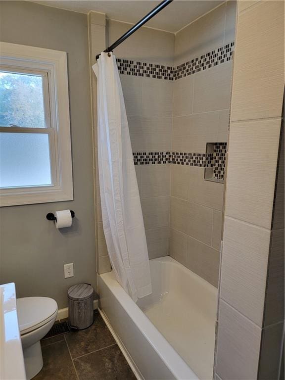 bathroom with tile patterned floors, toilet, and shower / bathtub combination with curtain