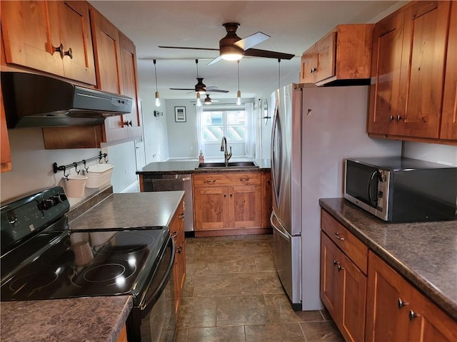 kitchen featuring ceiling fan, stainless steel appliances, and sink