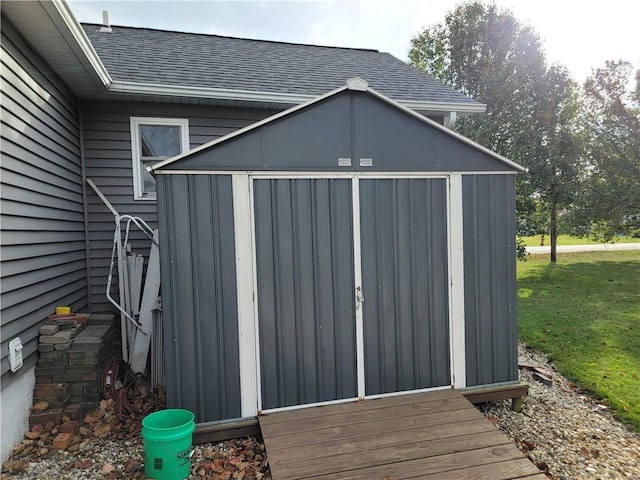 view of outbuilding with a yard