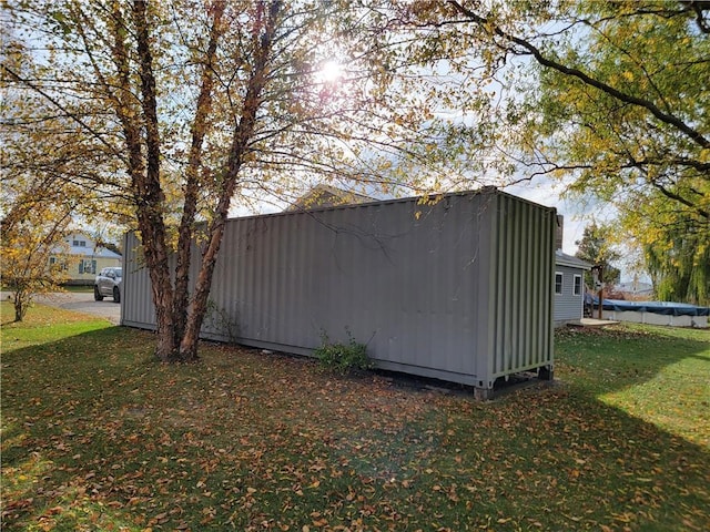 view of outbuilding featuring a yard