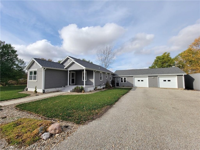 ranch-style house with a front yard and an outbuilding