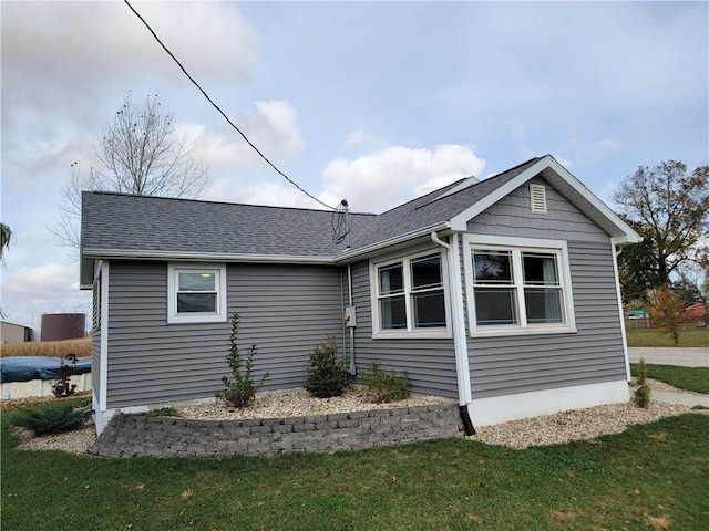 view of side of property with a yard