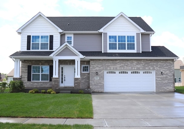 craftsman-style house with a garage and a front lawn