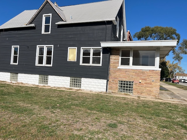 view of side of property with a lawn