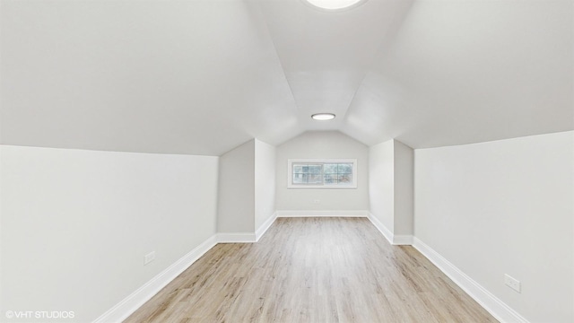 bonus room featuring light hardwood / wood-style flooring and vaulted ceiling