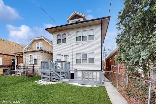 rear view of house featuring a deck and a yard