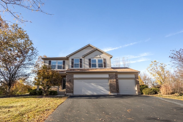 view of front property with a front lawn and a garage