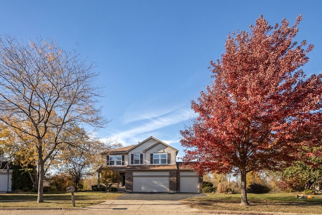 view of front facade featuring a garage and a front lawn