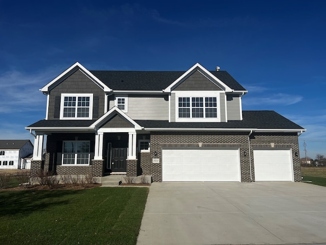 craftsman-style house featuring a garage, a front lawn, and a porch