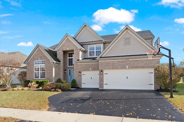 view of front facade with a front yard and a garage