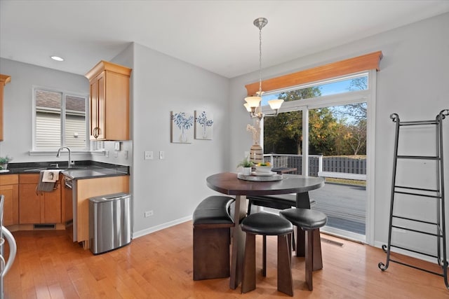 dining space featuring light hardwood / wood-style flooring and sink