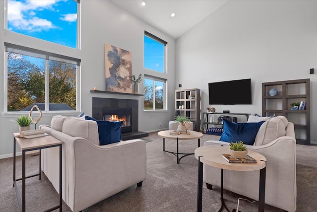 carpeted living room with a tile fireplace and high vaulted ceiling