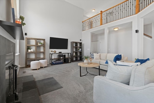 living room with carpet and a towering ceiling