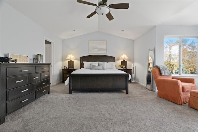 bedroom with ceiling fan, light colored carpet, and vaulted ceiling