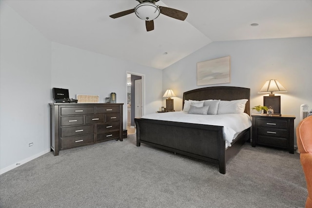 bedroom featuring light carpet, ensuite bathroom, vaulted ceiling, and ceiling fan