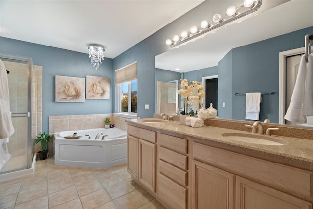 bathroom featuring tile patterned flooring, vanity, and separate shower and tub