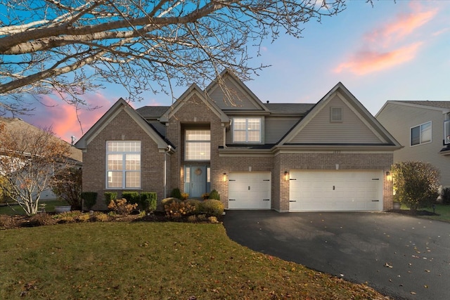 view of front of house with a yard and a garage