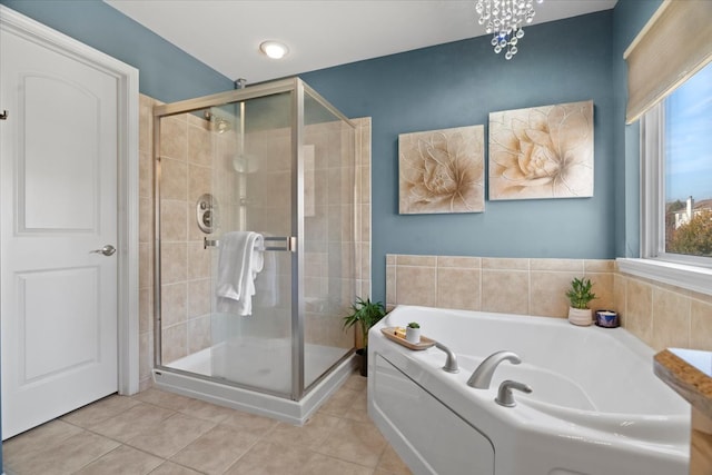 bathroom with tile patterned flooring and separate shower and tub