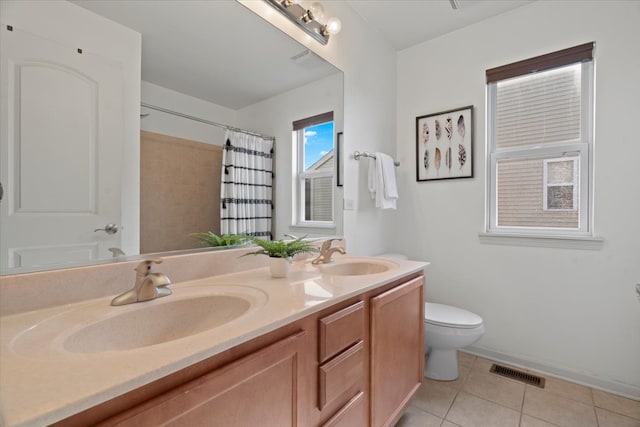 bathroom with tile patterned flooring, vanity, a shower with shower curtain, and toilet