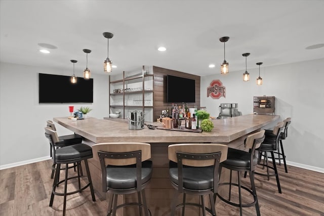 bar with hardwood / wood-style floors