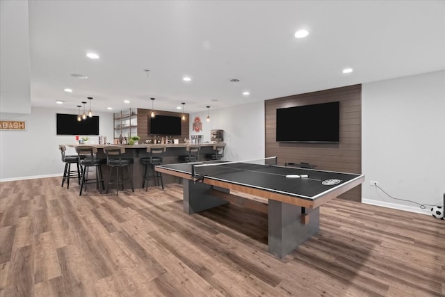 recreation room featuring hardwood / wood-style floors and indoor bar