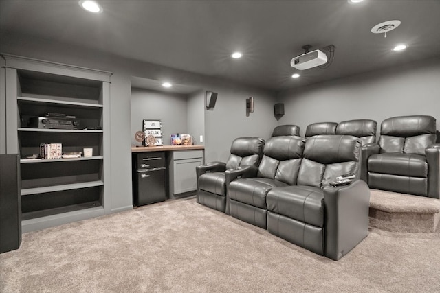 cinema room with built in features and light carpet