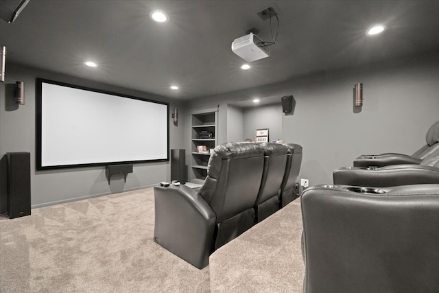 carpeted home theater room with built in shelves