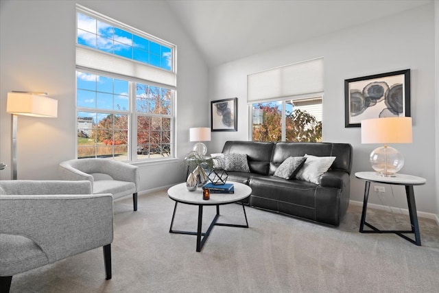 living room with light carpet, a healthy amount of sunlight, and vaulted ceiling