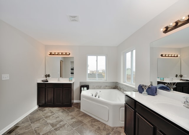 bathroom with vanity and a bath