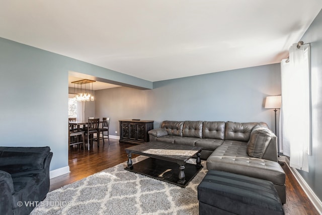 living room featuring dark hardwood / wood-style floors and a notable chandelier