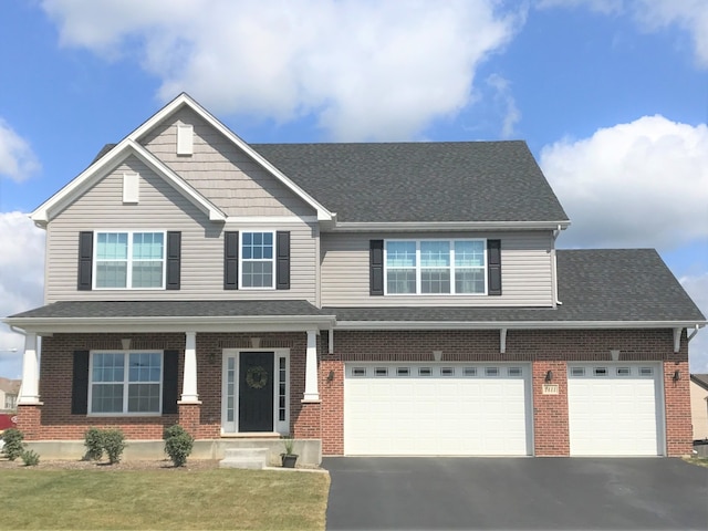 view of front of home with a front yard and a garage