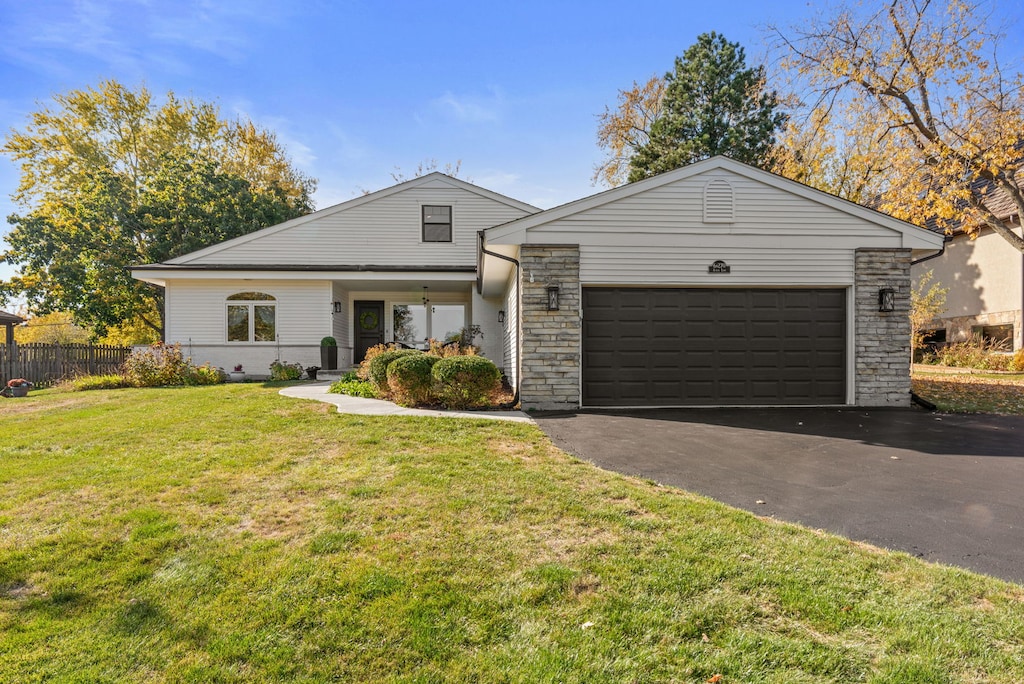 ranch-style house with a front yard and a garage