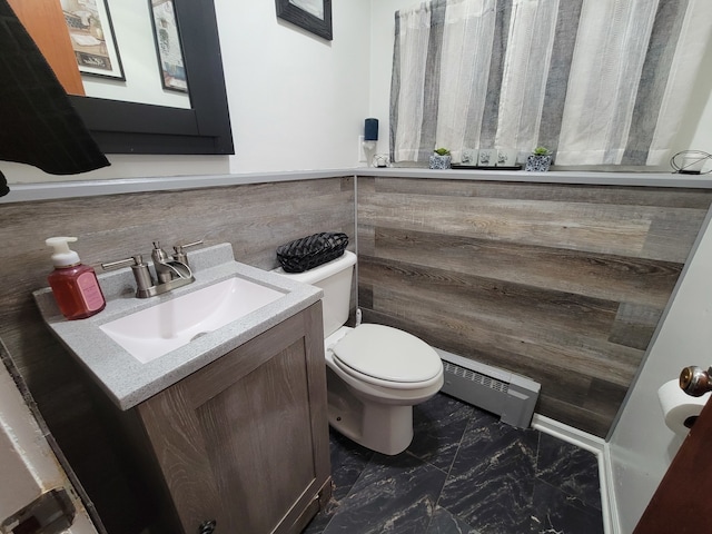 bathroom with a baseboard radiator, vanity, and toilet