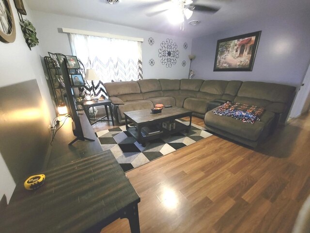 living room with ceiling fan and wood-type flooring