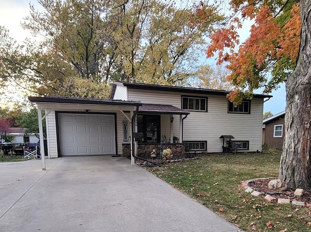 tri-level home featuring a garage and a front yard