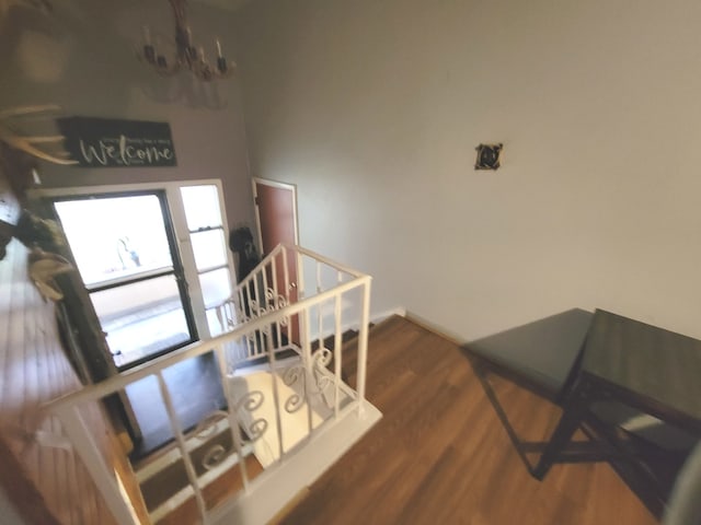 interior space featuring dark hardwood / wood-style flooring and an inviting chandelier