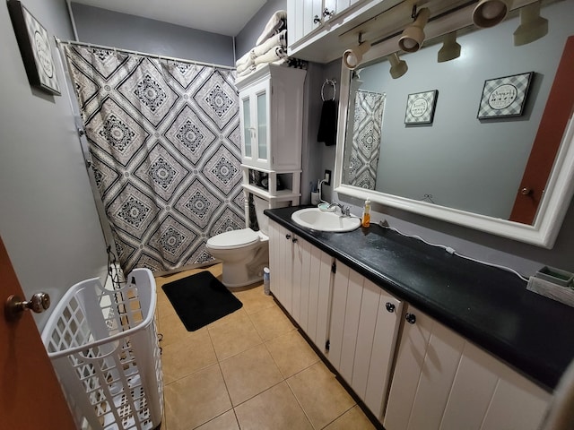 bathroom featuring vanity, tile patterned floors, and toilet