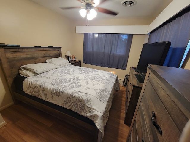 bedroom featuring ceiling fan and dark hardwood / wood-style flooring