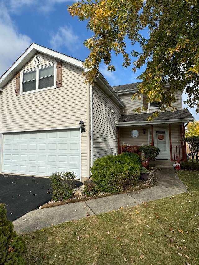 front of property with a garage and a front lawn