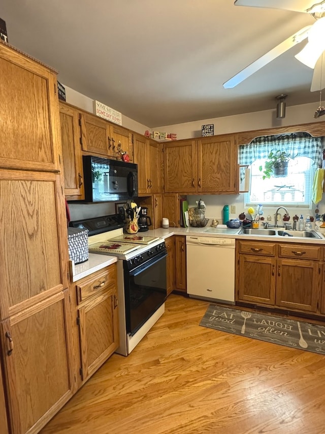 kitchen featuring white appliances, ceiling fan, sink, and light hardwood / wood-style floors